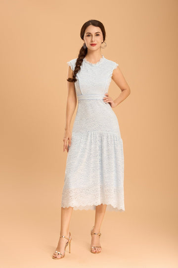 Model in a pastel blue lace midi dress by Vanda Modes, featuring a fitted waist and soft flared hem for graceful movement.