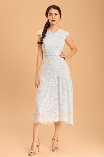 Model wearing a pastel blue midi lace dress by Vanda Modes, styled for elegant office wear or a chic weekend lunch.