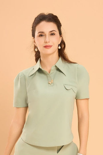 Model wearing the Wonder Shirt in mint green by Vanda Modes, featuring a Vanda's signature Orchid motif collar and front pocket, styled with matching bottoms against a warm beige backdrop.